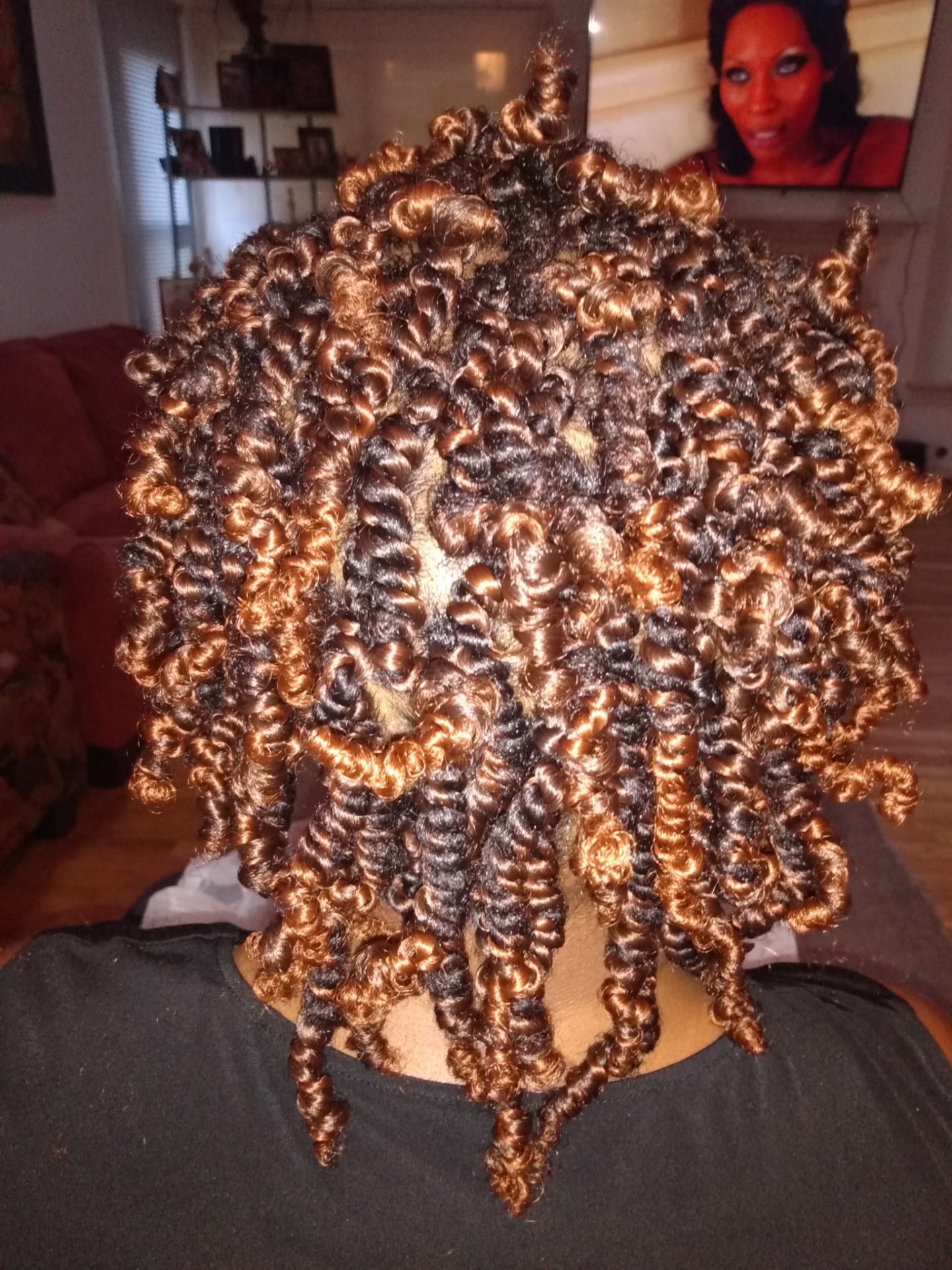 Short honey-blonde curled kinky twists